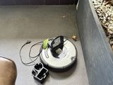 un robot posé par terre à côté d'une plante