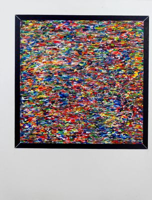 an abstract painting of multicolored paint on a white wall