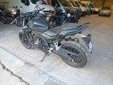 many motorcycles parked in a garage with a van in the background
