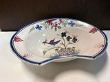a bowl that has a bird on it on a table