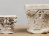 two white vases sitting next to each other on a table