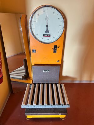 a clock that is sitting on a cart in a room