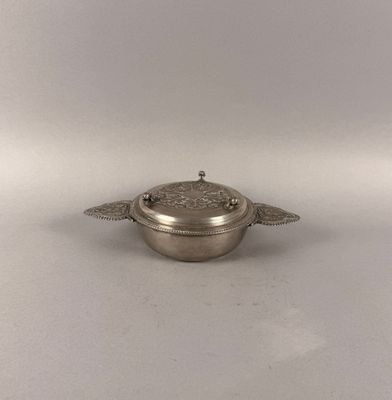 an antique silver plated bowl with a lid and two wings on it