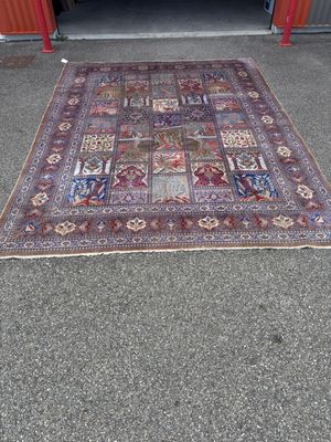 rug on the ground in front of a garage with a door open