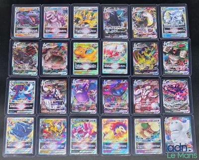 a large collection of pokemon cards in plastic cases on a table