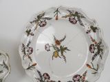 two plates with flowers on them on a table