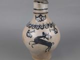 a small vase with a black and white design on it
