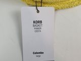 yellow knitted hat with a tag attached to it on a white surface