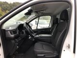 the interior of a white van with the door open and the driver ' s seat down