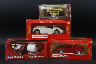 three boxed boxes of toy cars on a black surface