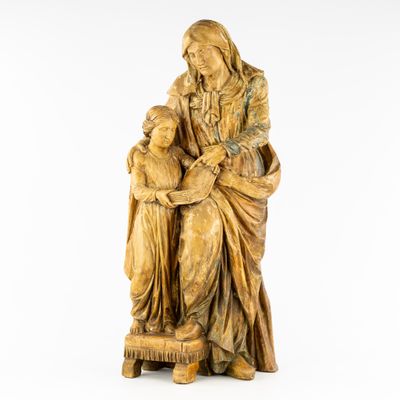 a statue of a woman holding a child in her lap