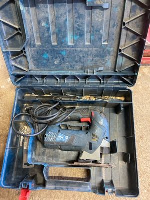 an image of a tool box with a corded drill in it