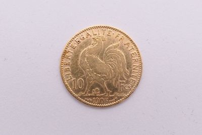 gros plan d'une pièce d'or sur une surface blanche