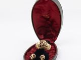 an image of a box with three gold skulls inside of it