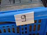 a blue shopping basket with a red car inside of it