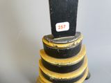 a clock that is sitting on top of a stack of yellow and black plates