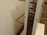 an image of a metal shelf with a clock on it