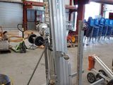 a picture of a forklift in a warehouse with pallets in the background