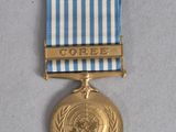 an image of a gold medal with a blue and white ribbon around it