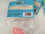 three pink soap balls in a plastic bag on a table