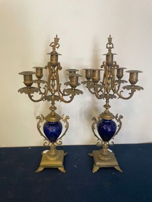 pair of antique brass candelabs with blue vases on stands