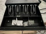 an image of a cash register with a lot of items in it
