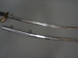 two swords that are on display on a table