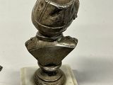 a statue of a man with a helmet on a marble base