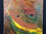 une photo d'une peinture représentant un visage sur une feuille de papier