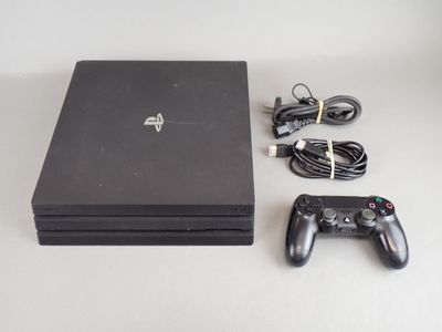 a video game console and a game controller on a table