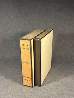 an old book sitting on top of a table next to a gray background