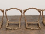 four pieces of wood sitting on the floor in front of a white wall