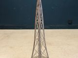 an image of a metal tower with a candle on top of it
