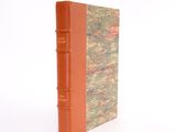 a book with a red cover sitting on a white surface