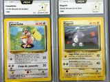 two pokemon cards in plastic cases sitting on top of a table