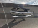 a reflection of a car door handle on the side of the car