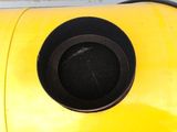 a yellow object with a black hole in it