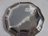 a silver plate on a white table with a sticker on it