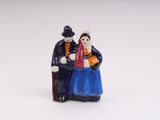 a figurine of a man and a woman sitting on a bench