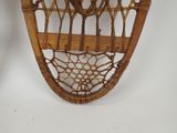 a snowshoe hanging on the wall in the corner of the room