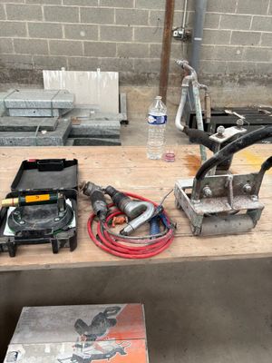 some tools are sitting on a wooden table in a room
