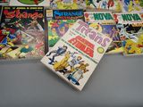 a lot of comic books on the table
