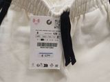 the back of a pair of white sweatpants with a tag on it