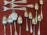 a lot of silver spoons and spoon spoons on the table