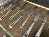 a lot of knives that are sitting on a table