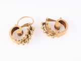 pair of gold earrings with pearls on each side