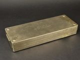 silver plated box with writing on it sitting on a black surface