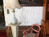 a lamp and a chair in the corner of a room