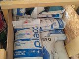 a wooden box filled with bags of cement next to a pile of bags
