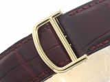 brown leather watch strap with gold buckle on a white background